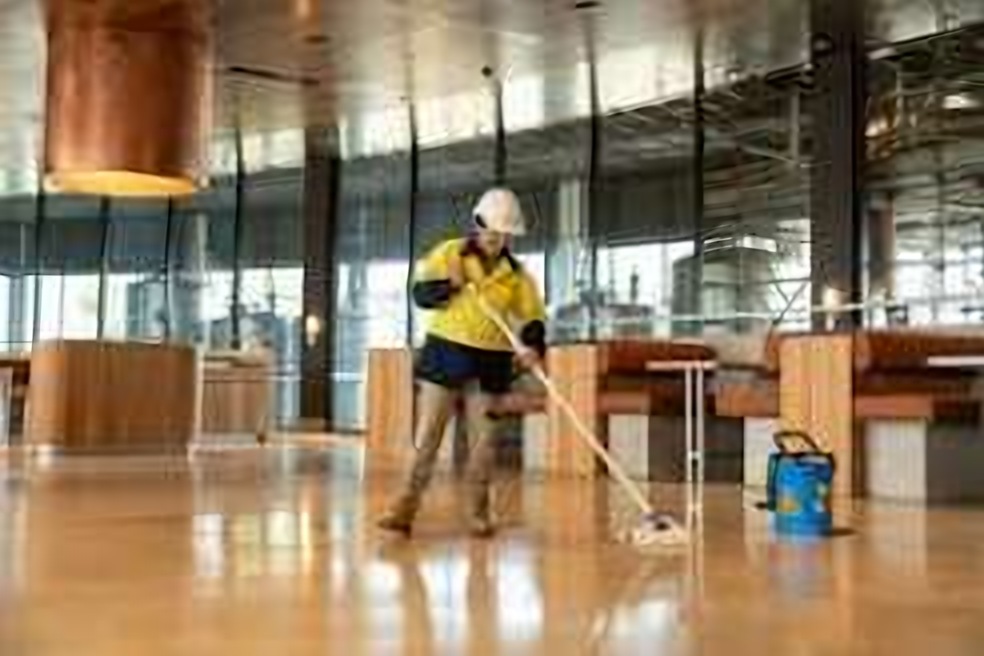 Cleaner mopping a newly finished interior