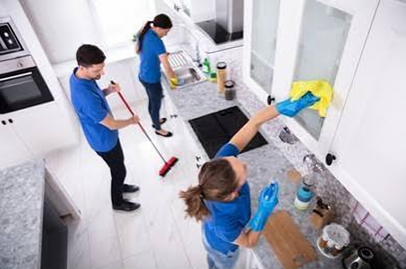 Cleaning team working together in a kitchen