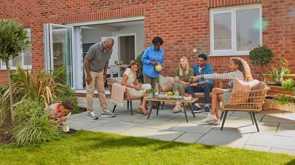 Family relaxing in a landscaped garden and patio
